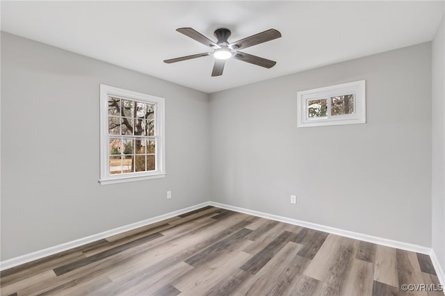 empty room featuring hardwood / wood-style floors, plenty of natural light, and ceiling fan