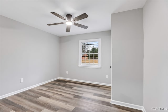 empty room with ceiling fan and light hardwood / wood-style floors