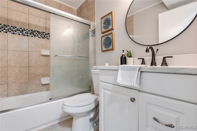 full bathroom featuring enclosed tub / shower combo, vanity, toilet, and tile patterned floors