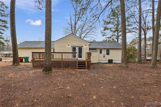 rear view of house featuring central AC unit and a deck