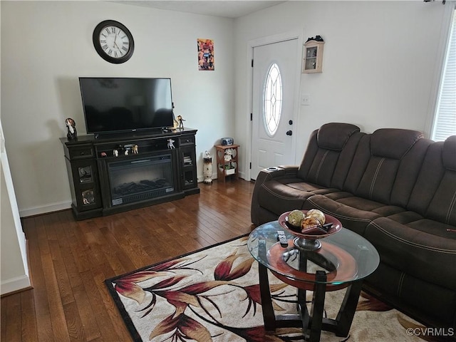 living room featuring hardwood / wood-style floors and baseboards