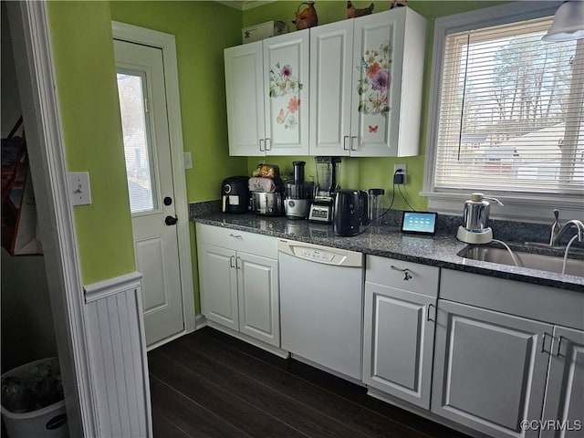kitchen with dishwasher, white cabinets, and a sink