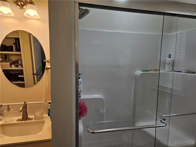 bathroom with vanity and a shower stall