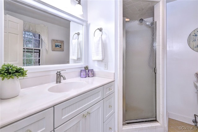 full bath with a shower stall and vanity