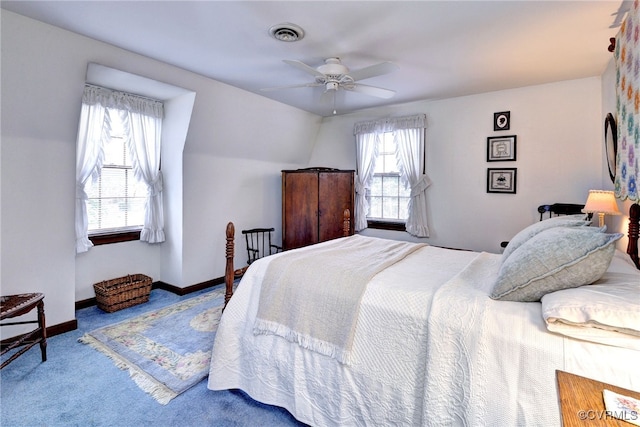 carpeted bedroom featuring baseboards, visible vents, and ceiling fan