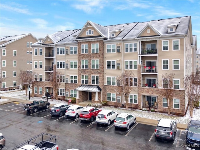 view of building exterior with uncovered parking