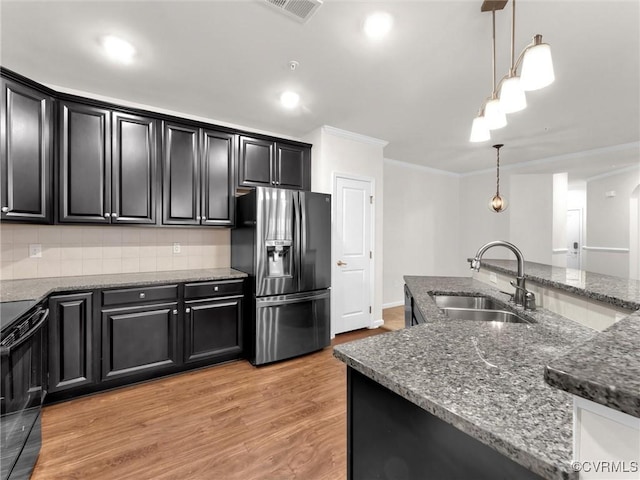 kitchen with dark cabinetry, fridge with ice dispenser, black range with electric cooktop, and a sink