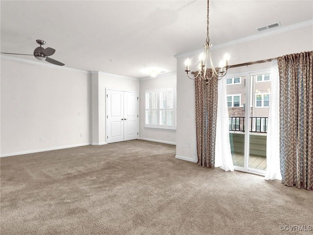 carpeted empty room with ceiling fan with notable chandelier, baseboards, visible vents, and ornamental molding