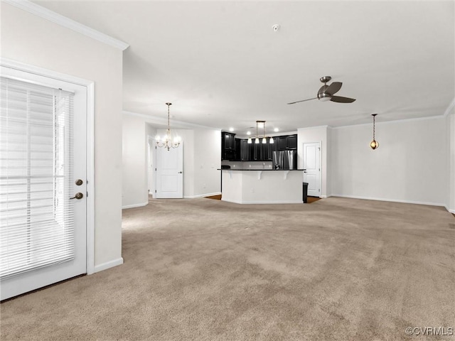 unfurnished living room with light carpet, ceiling fan with notable chandelier, baseboards, and ornamental molding