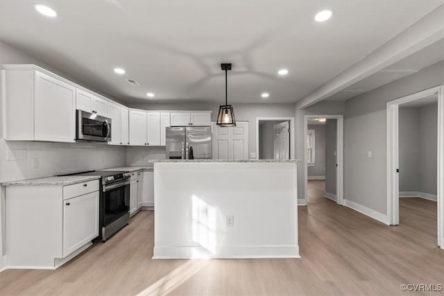 kitchen with stainless steel appliances, light wood-type flooring, a kitchen island, and white cabinetry