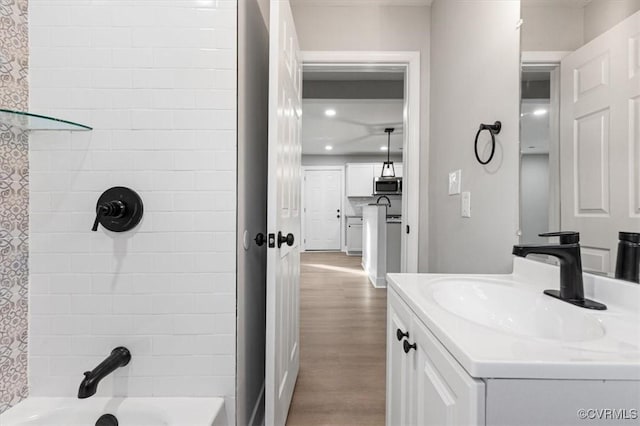 bathroom with wood finished floors, vanity, and recessed lighting