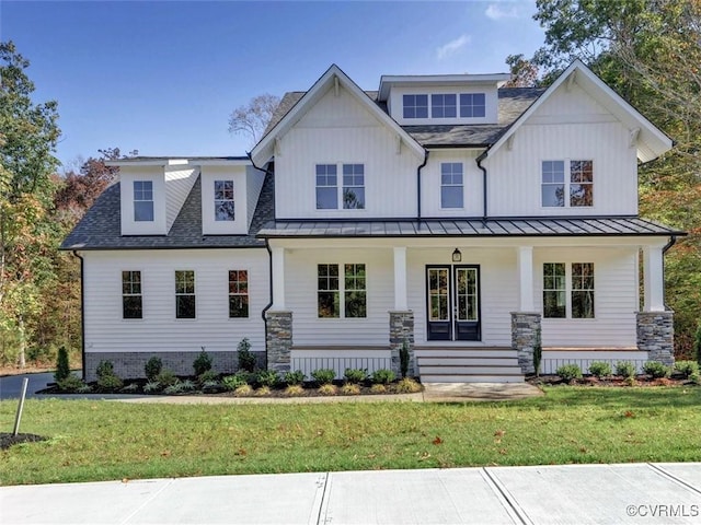 modern farmhouse with a front lawn and a porch