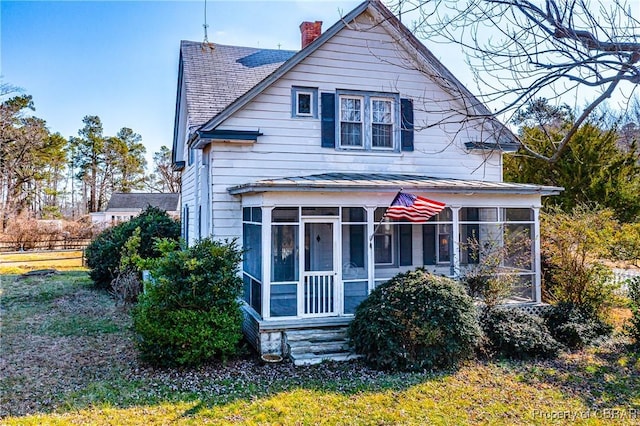 view of front facade with a sunroom