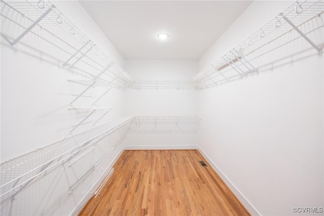 spacious closet featuring light wood-style flooring and visible vents