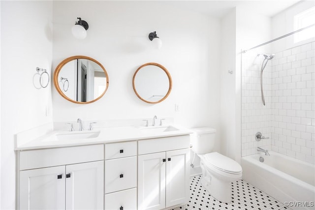 bathroom with a sink, shower / bathing tub combination, toilet, and double vanity