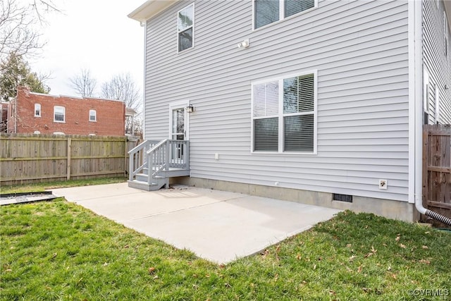 back of property with a yard, crawl space, a patio area, and fence