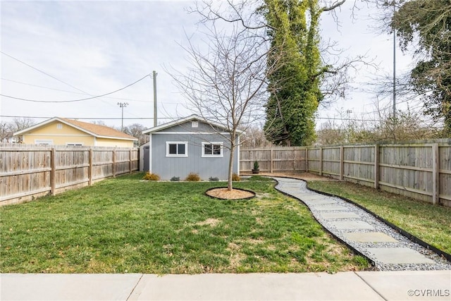 view of yard with a fenced backyard and an outdoor structure