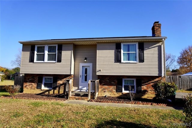 bi-level home with a front lawn