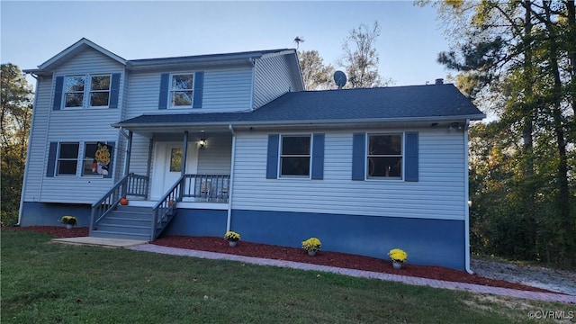 front facade featuring a front lawn and covered porch