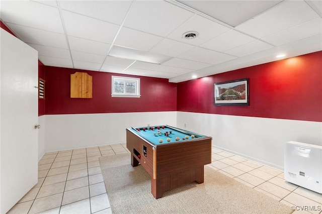 recreation room with a drop ceiling, tile patterned flooring, visible vents, and baseboards