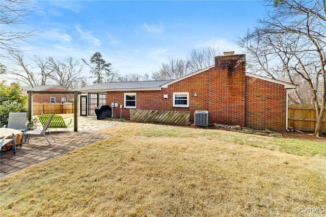 back of house with a patio, brick siding, fence, and central air condition unit