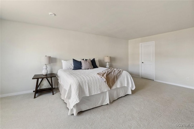 bedroom featuring light carpet and baseboards