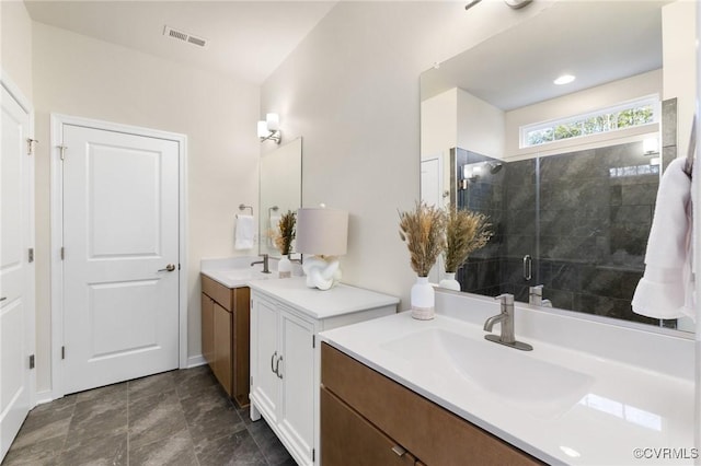 bathroom featuring two vanities, a sink, visible vents, and a shower stall