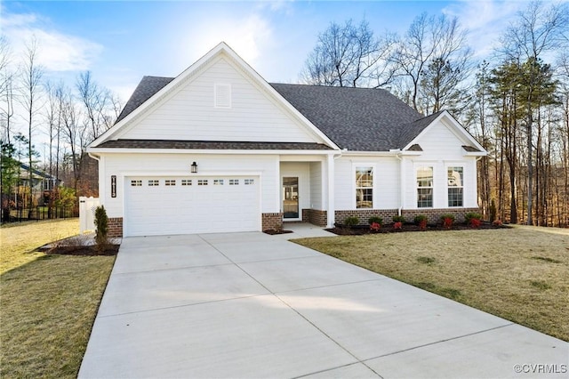 view of front of property with a front yard, concrete driveway, brick siding, and an attached garage