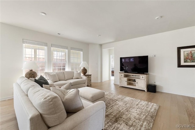 living area with baseboards and light wood-style floors