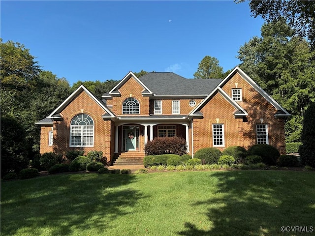 view of front facade with a front lawn and brick siding