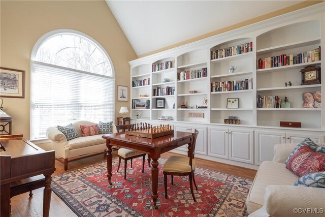 sitting room with vaulted ceiling and light wood finished floors