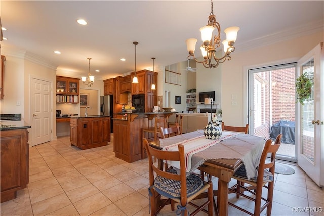 dining area with light tile patterned floors, ornamental molding, a notable chandelier, and recessed lighting