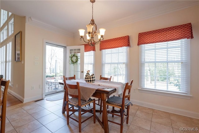 dining space featuring a chandelier, light tile patterned floors, baseboards, and crown molding