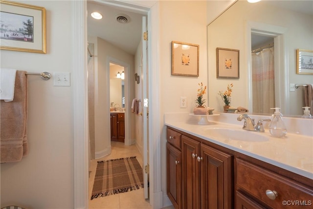 full bath featuring visible vents, vanity, and tile patterned floors