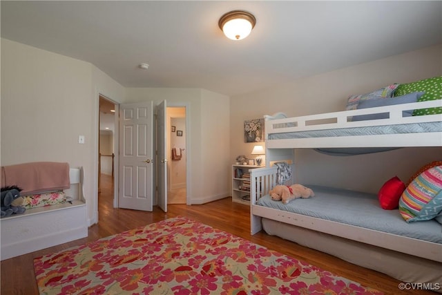 bedroom featuring wood finished floors and baseboards