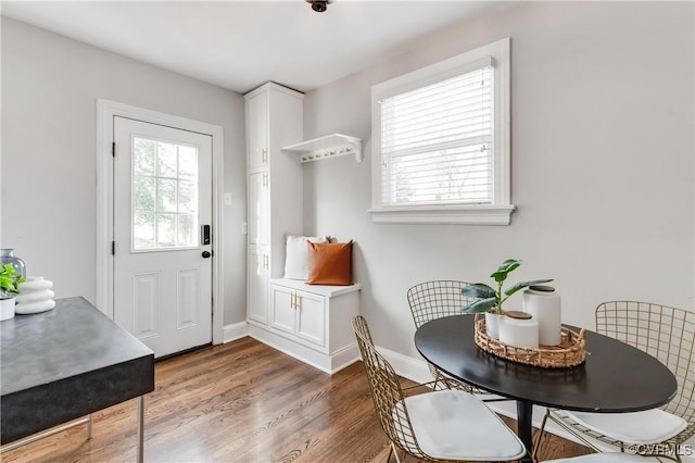 interior space featuring wood finished floors and baseboards