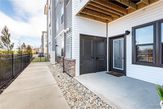 view of exterior entry featuring a patio area