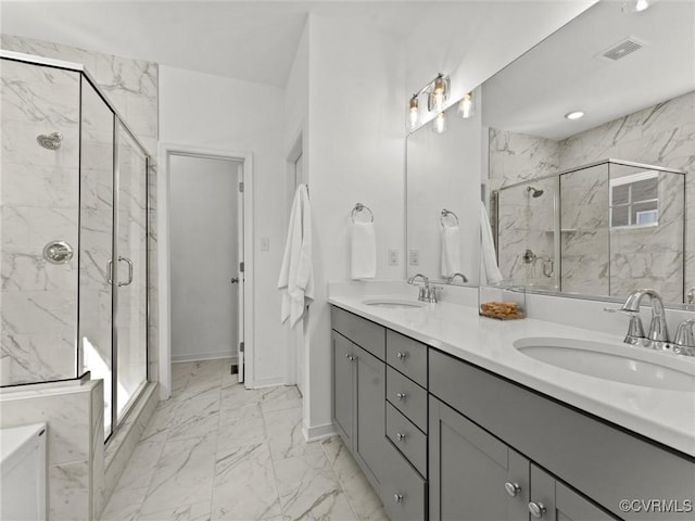 full bath with marble finish floor, double vanity, a sink, and a marble finish shower