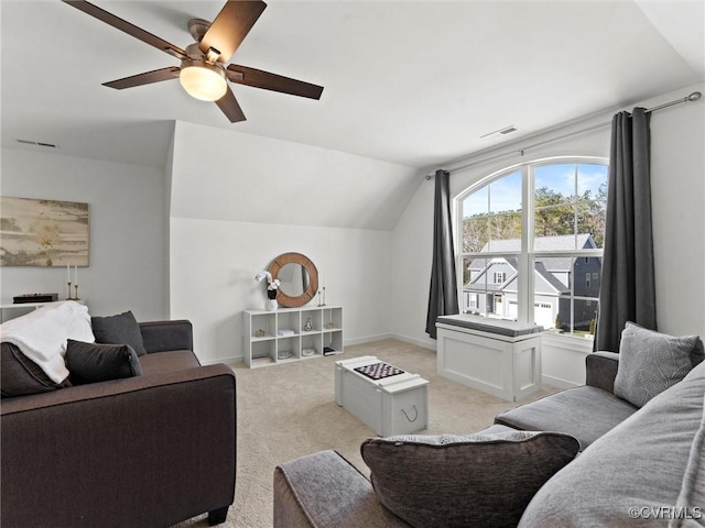 living room featuring baseboards, visible vents, light colored carpet, lofted ceiling, and ceiling fan