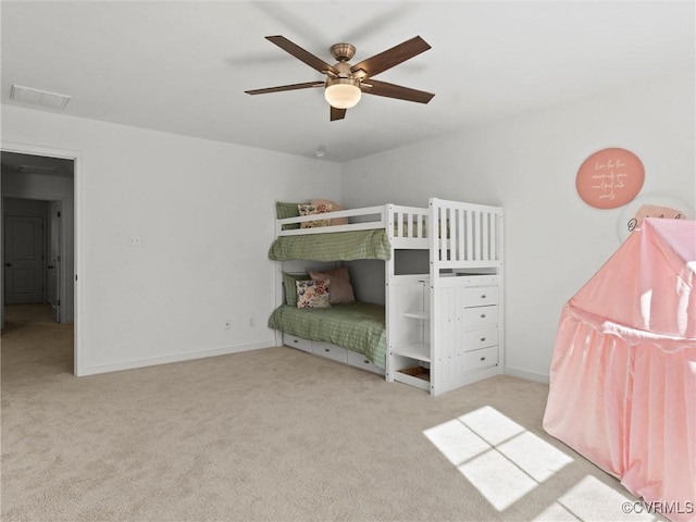 unfurnished bedroom featuring light colored carpet, ceiling fan, and baseboards