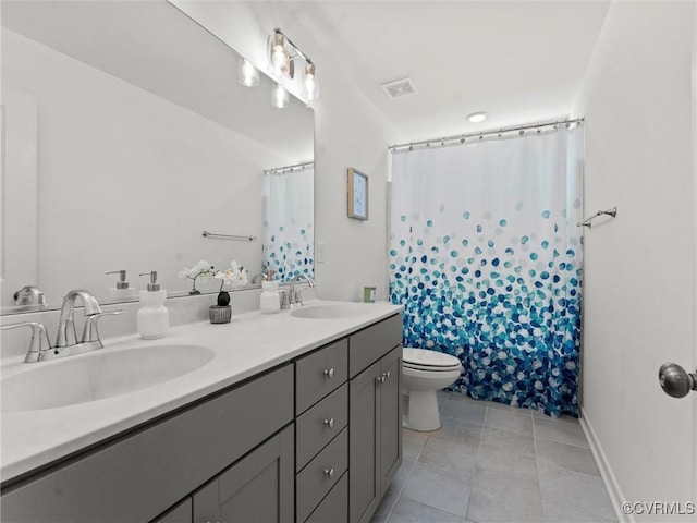 full bath featuring double vanity, tile patterned flooring, visible vents, and a sink