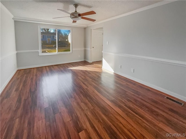 spare room with ceiling fan, ornamental molding, dark hardwood / wood-style flooring, and a textured ceiling