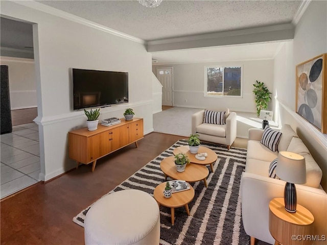 living room featuring ornamental molding, dark tile patterned flooring, and a textured ceiling