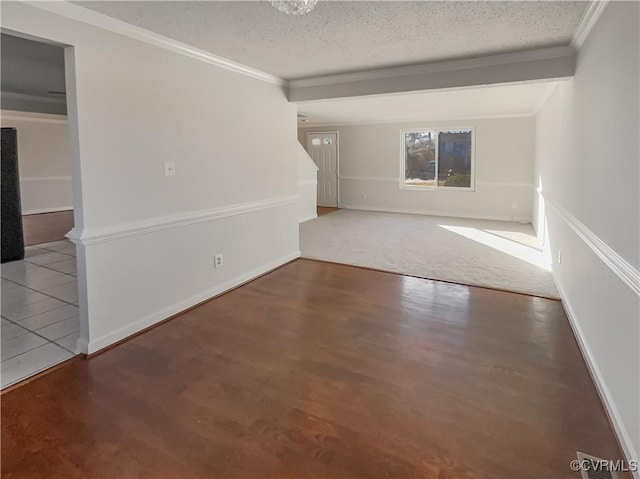 unfurnished room featuring ornamental molding and a textured ceiling