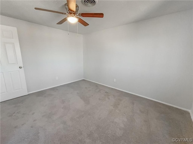 spare room with ceiling fan and carpet