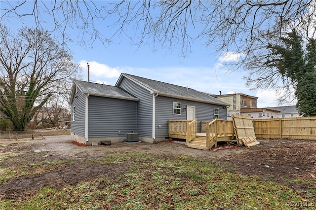 back of house with central AC unit and a deck