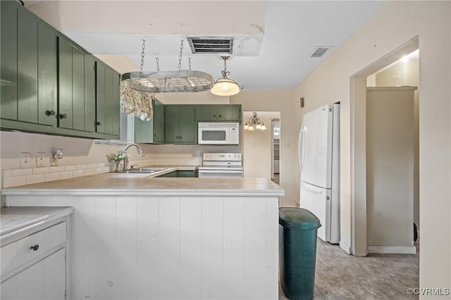 kitchen featuring sink, white appliances, kitchen peninsula, and green cabinets