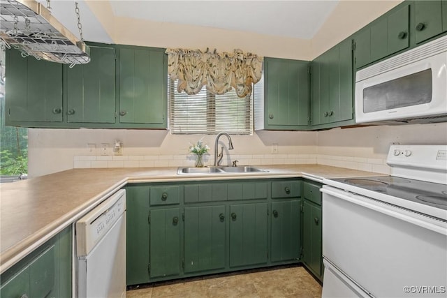 kitchen with sink, green cabinets, and white appliances