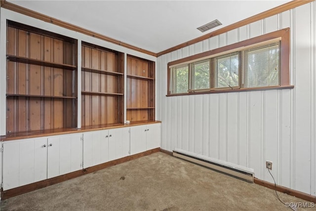 carpeted empty room with a baseboard radiator and crown molding