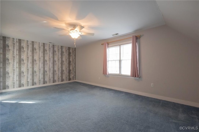 additional living space featuring ceiling fan, carpet flooring, baseboards, vaulted ceiling, and wallpapered walls